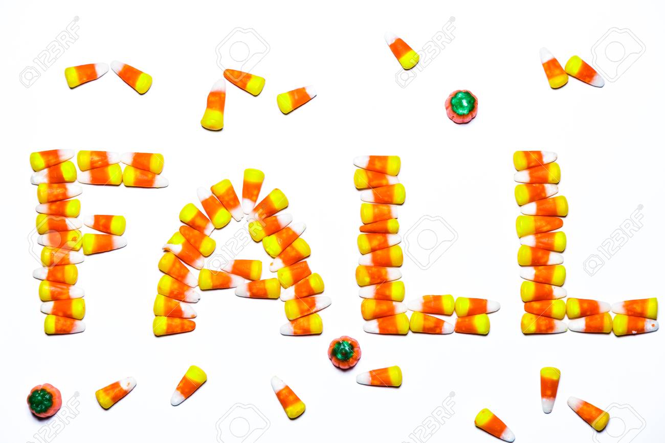 the word fall is spelled using tri colored candy corn candy on word with tri