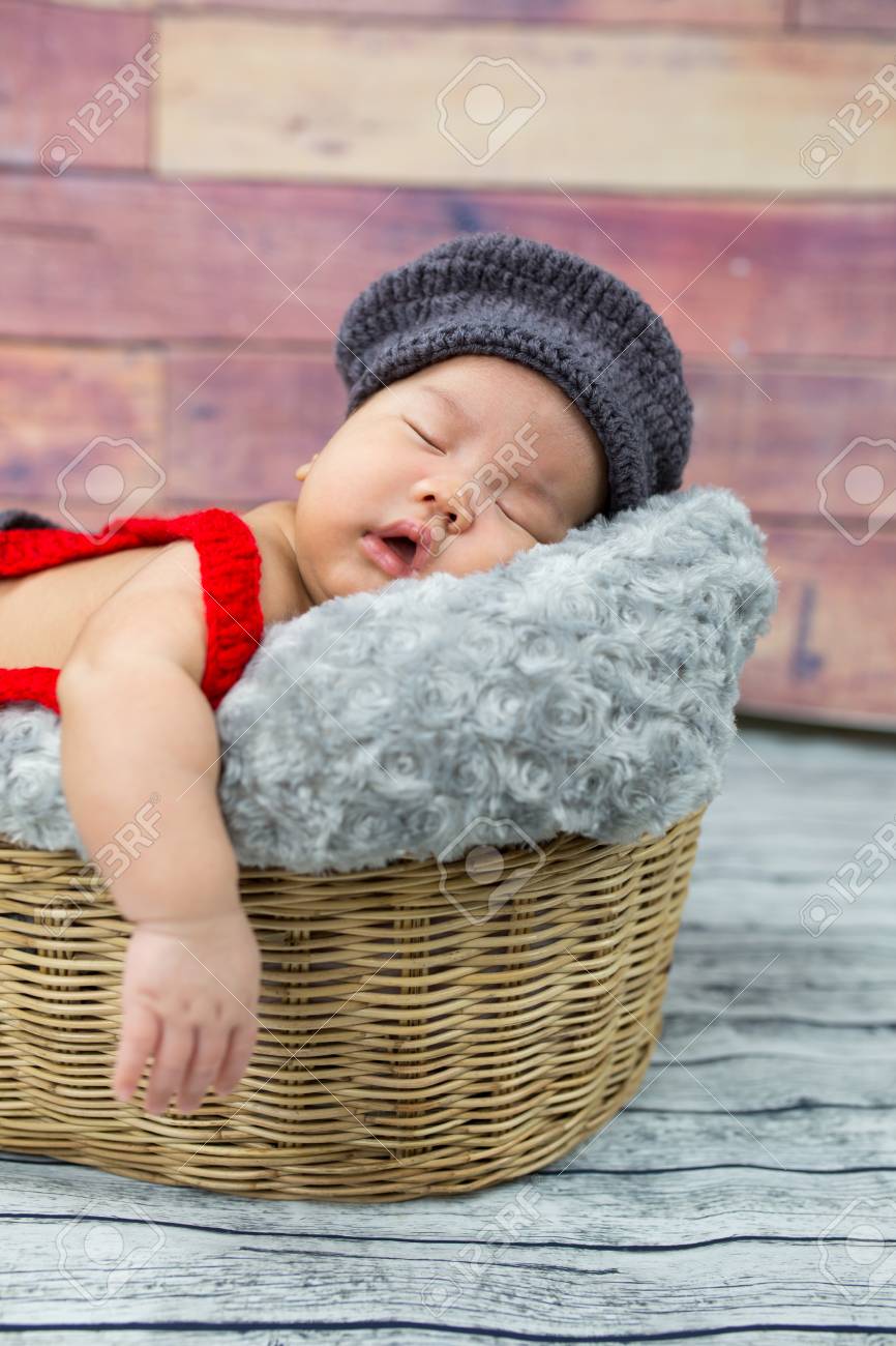 6 week old newborn boy sleeping in a basket stock photo picture