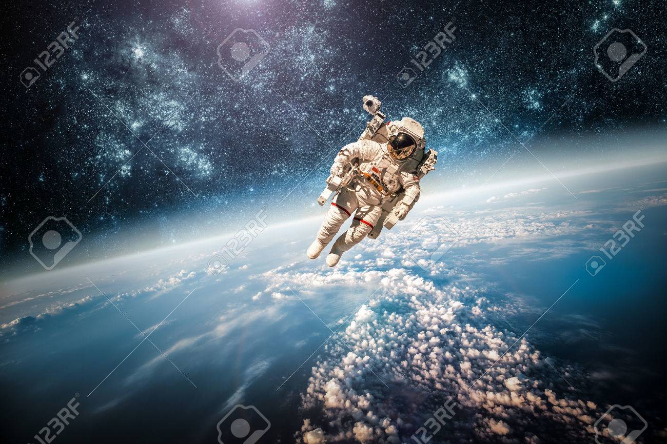 Astronaut in outer space against the backdrop of the planet earth. Elements of this image furnished by NASA. - 35122780 Astronaut in outer space against the backdrop of the planet earth. Elements of this image furnished by NASA. - 35122780