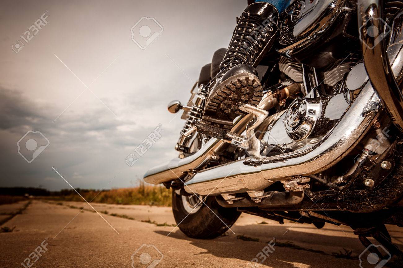 Biker girl riding on a motorcycle. Bottom view of the legs in leather boots. - 51825913 Biker girl riding on a motorcycle. Bottom view of the legs in leather boots. - 51825913