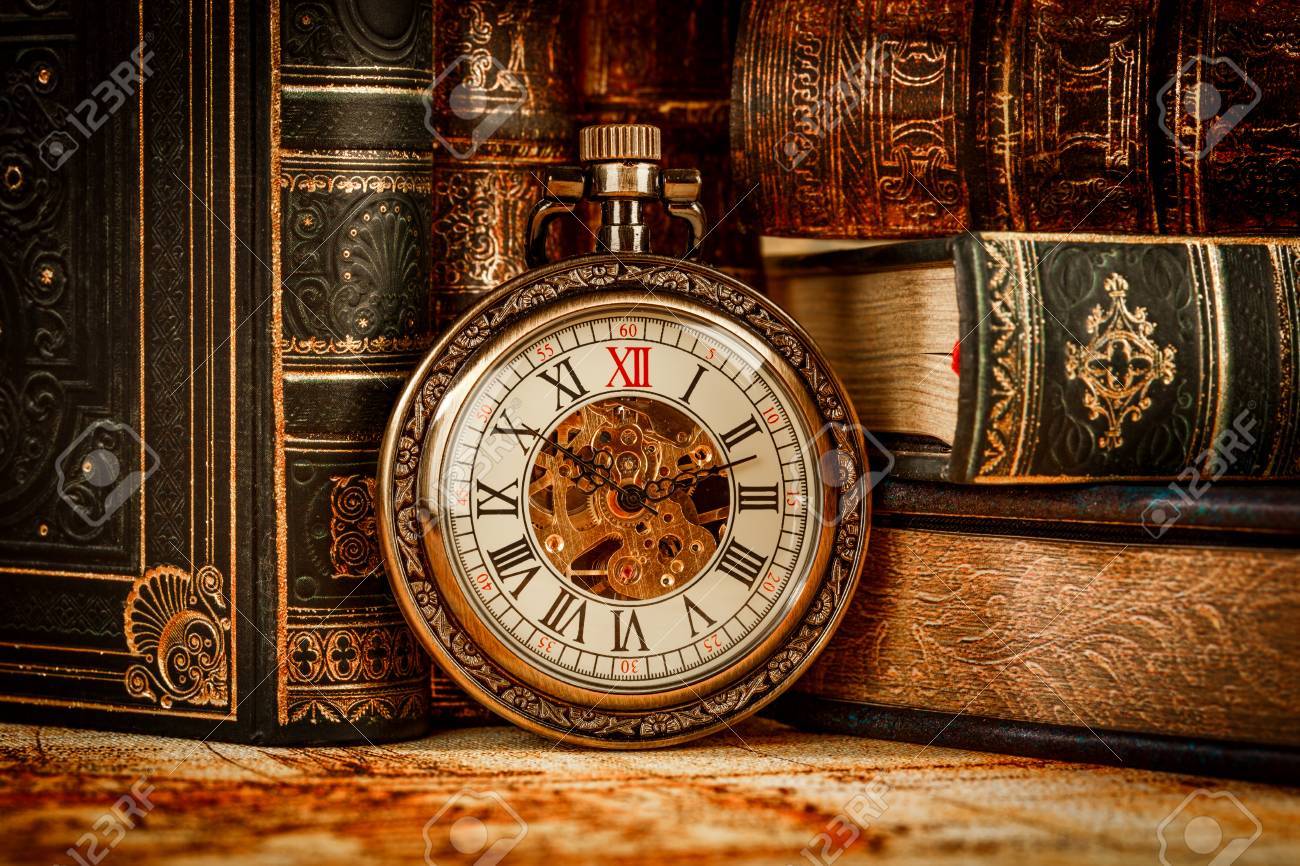 Vintage Antique pocket watch on the background of old books - 54767004 Vintage Antique pocket watch on the background of old books - 54767004