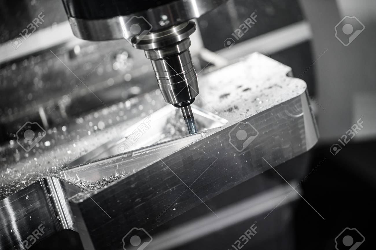 Metalworking CNC milling machine. Cutting metal modern processing technology. Small depth of field. Warning - authentic shooting in challenging conditions. A little bit grain and maybe blurred. - 57580709 Metalworking CNC milling machine. Cutting metal modern processing technology. Small depth of field. Warning - authentic shooting in challenging conditions. A little bit grain and maybe blurred. - 57580709