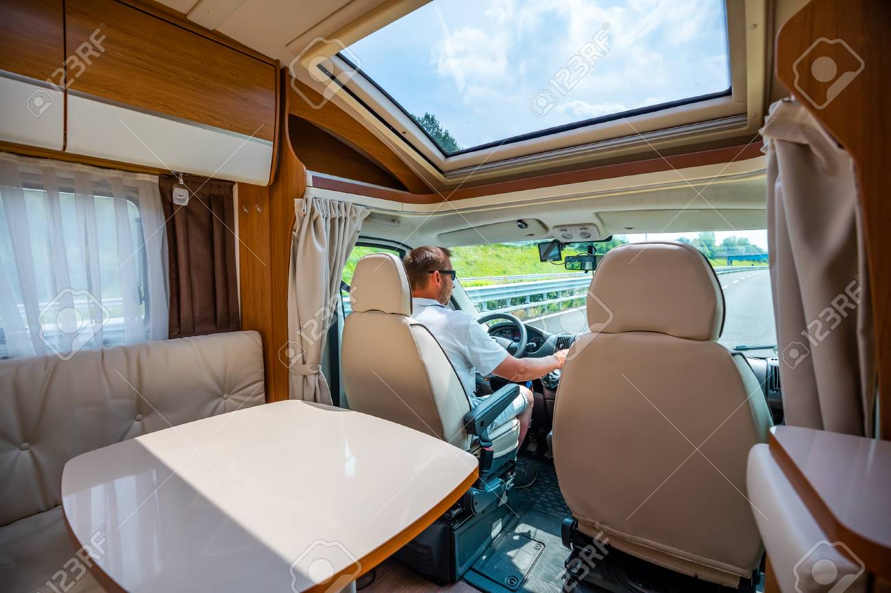 Man driving on a road in the Camper Van RV. Caravan car Vacation. Family vacation travel, holiday trip in motorhome - 107320810 Man driving on a road in the Camper Van RV. Caravan car Vacation. Family vacation travel, holiday trip in motorhome - 107320810