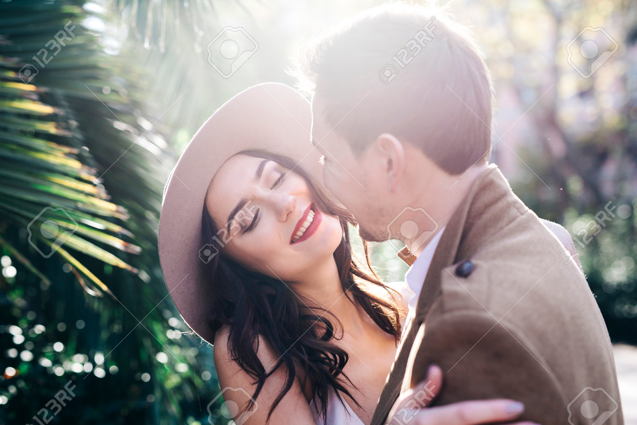 Young elegant fashion couple smiling in park - 76317059 Young elegant fashion couple smiling in park - 76317059