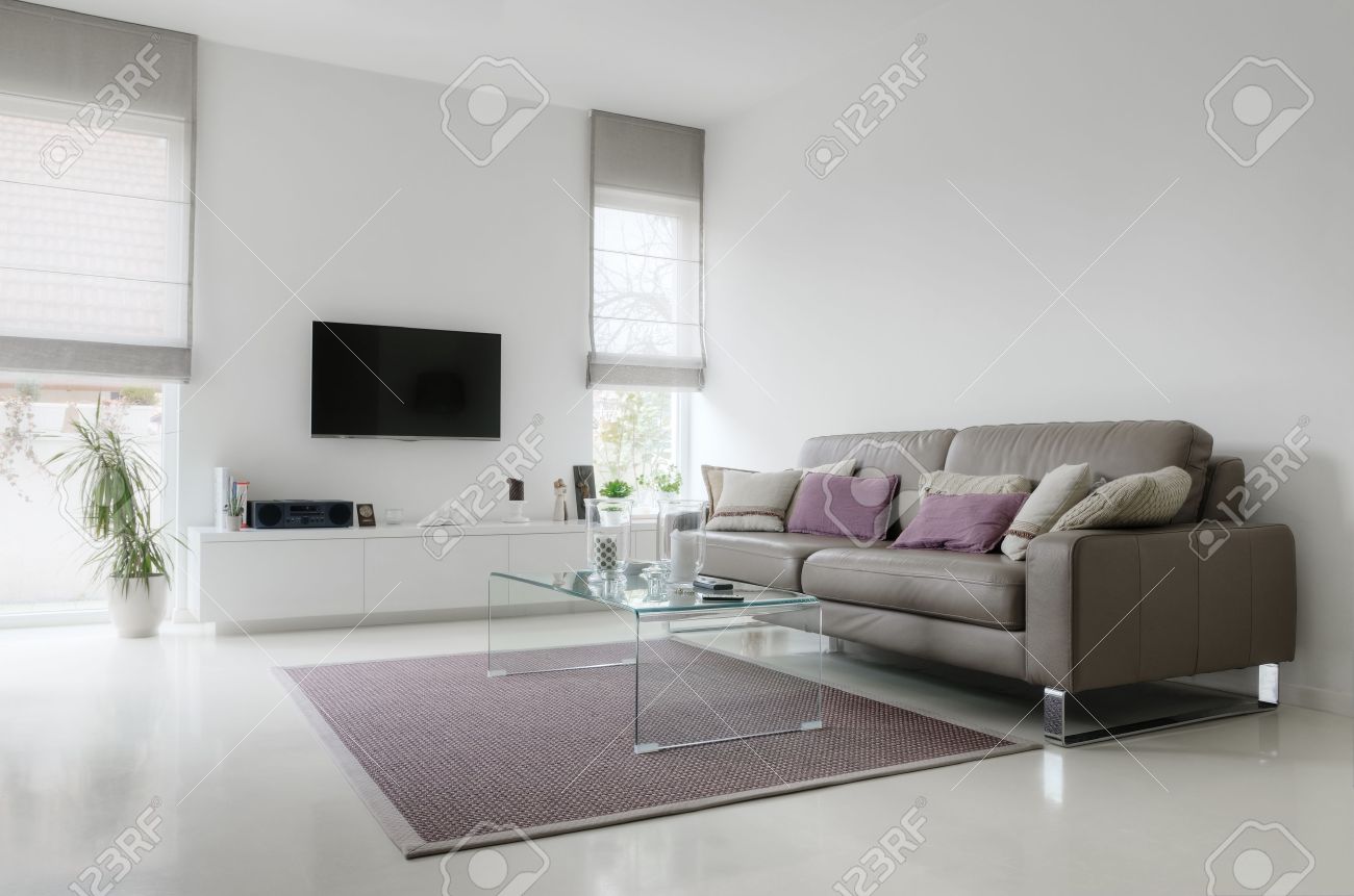 White Living Room With Taupe Leather Sofa And Glass Table On White Living Room With Taupe Leather Sofa And Glass Table On