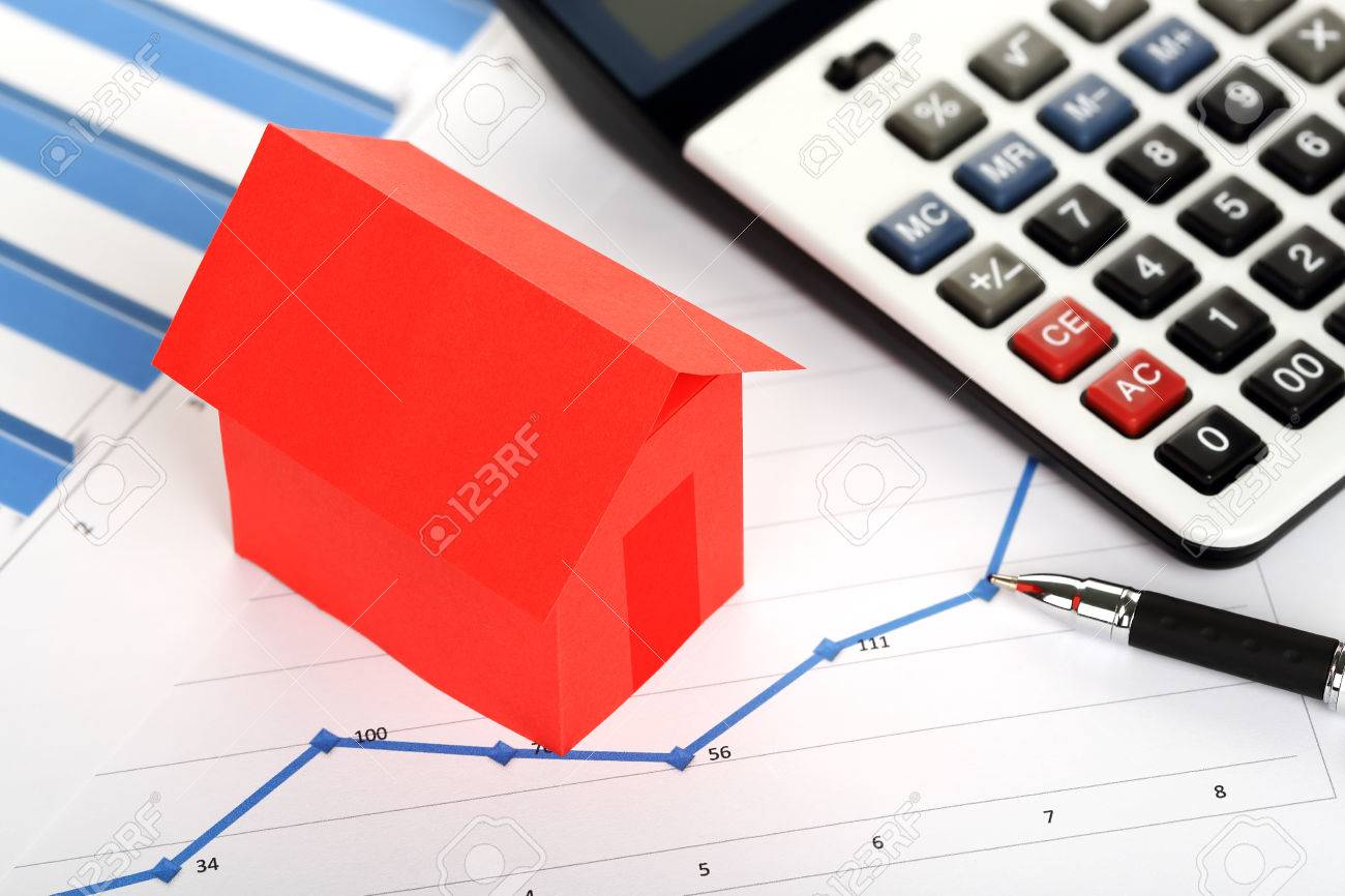 red paper house and calculator on graphs, real estate concept - 48929773 red paper house and calculator on graphs, real estate concept - 48929773