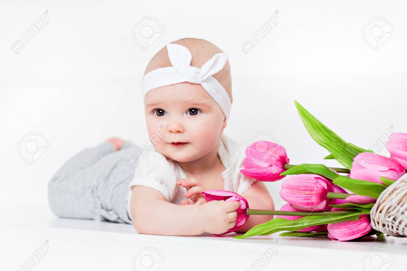 Small Very Cute Wide-eyed Smiling Baby Girl Lying On Her Tummy On ...