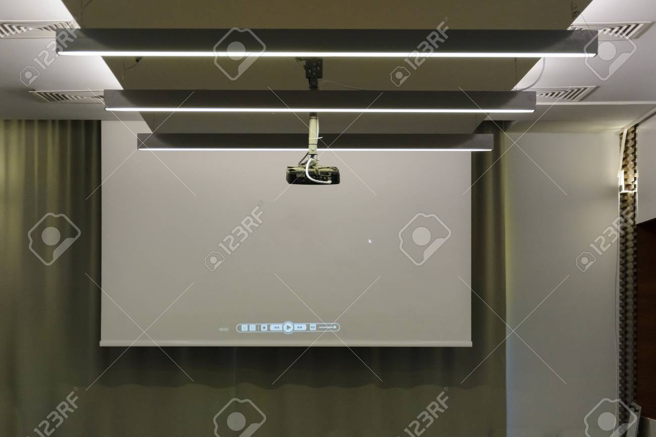 Projector In A Room With Projector Screen On Back Ground