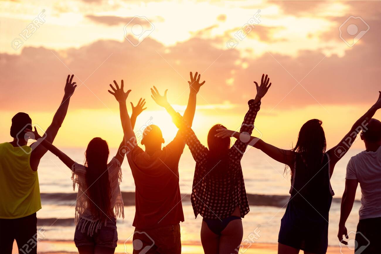 Silhouettes of six happy friends with raised arms stands against beautiful sunset sea beach - 131818591 Silhouettes of six happy friends with raised arms stands against beautiful sunset sea beach - 131818591