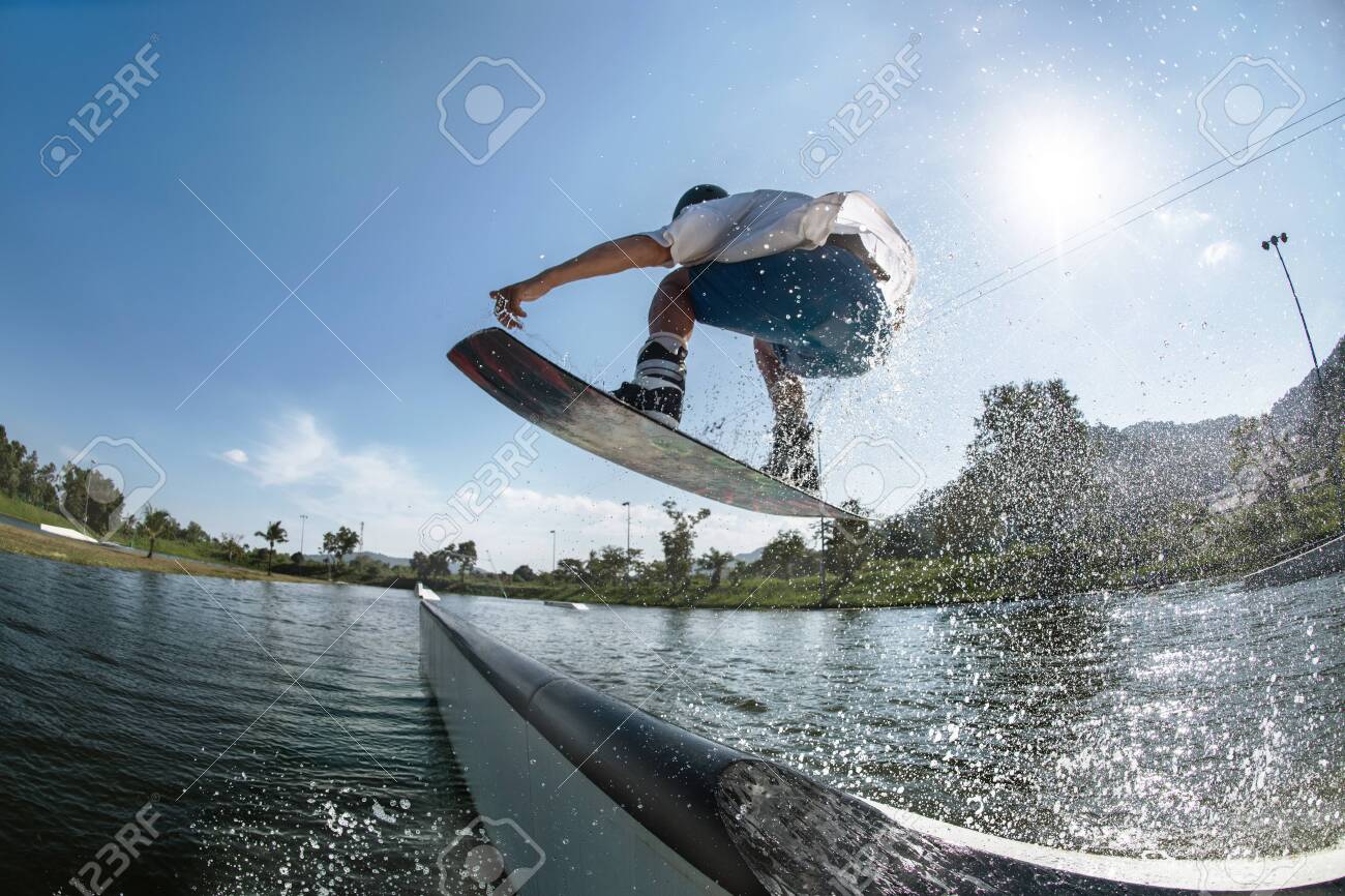Ma wakeboarder jumps at ramp at wake park - 147216045 Ma wakeboarder jumps at ramp at wake park - 147216045