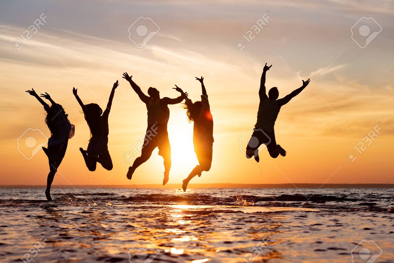 Five happy friends are having fun and jumping at sunset beach - 146421620 Five happy friends are having fun and jumping at sunset beach - 146421620