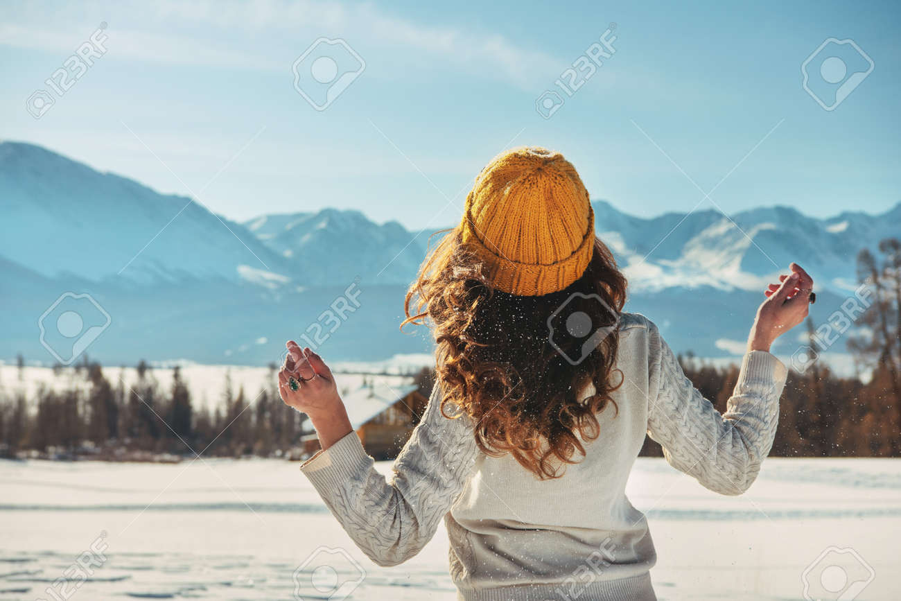 Attractive young girl walks in snowy mountains - 155882216 Attractive young girl walks in snowy mountains - 155882216