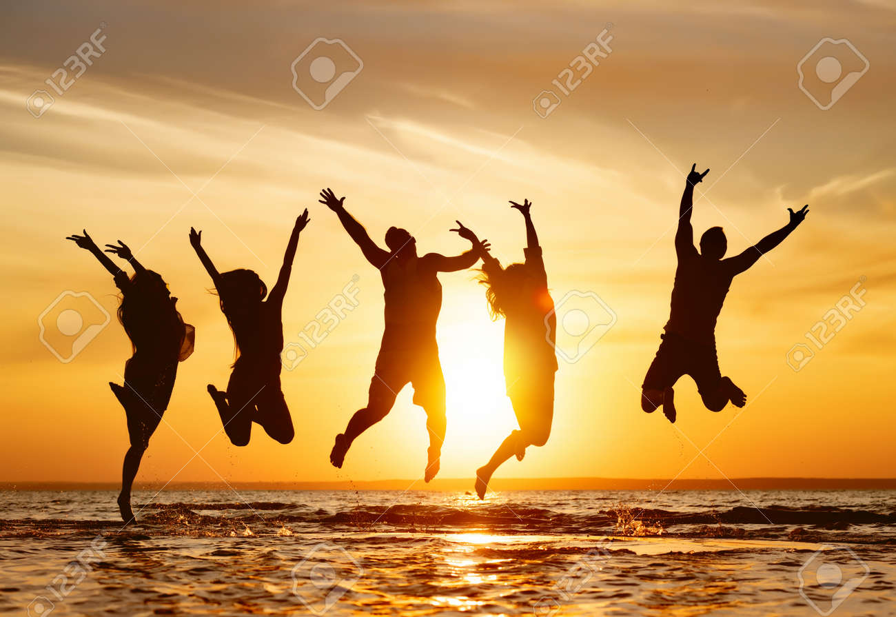 Silhouettes of five happy jumping friends in water at sunset time - 159459451 Silhouettes of five happy jumping friends in water at sunset time - 159459451