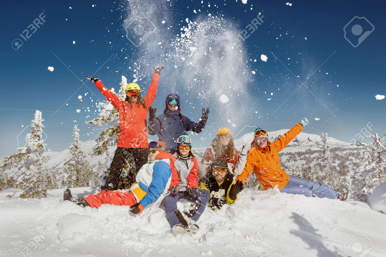 Group of young friends in colorful clothes are having fun and posing at the top of mountain. Winter ski and snowboarding vacations concept - 159677553 Group of young friends in colorful clothes are having fun and posing at the top of mountain. Winter ski and snowboarding vacations concept - 159677553