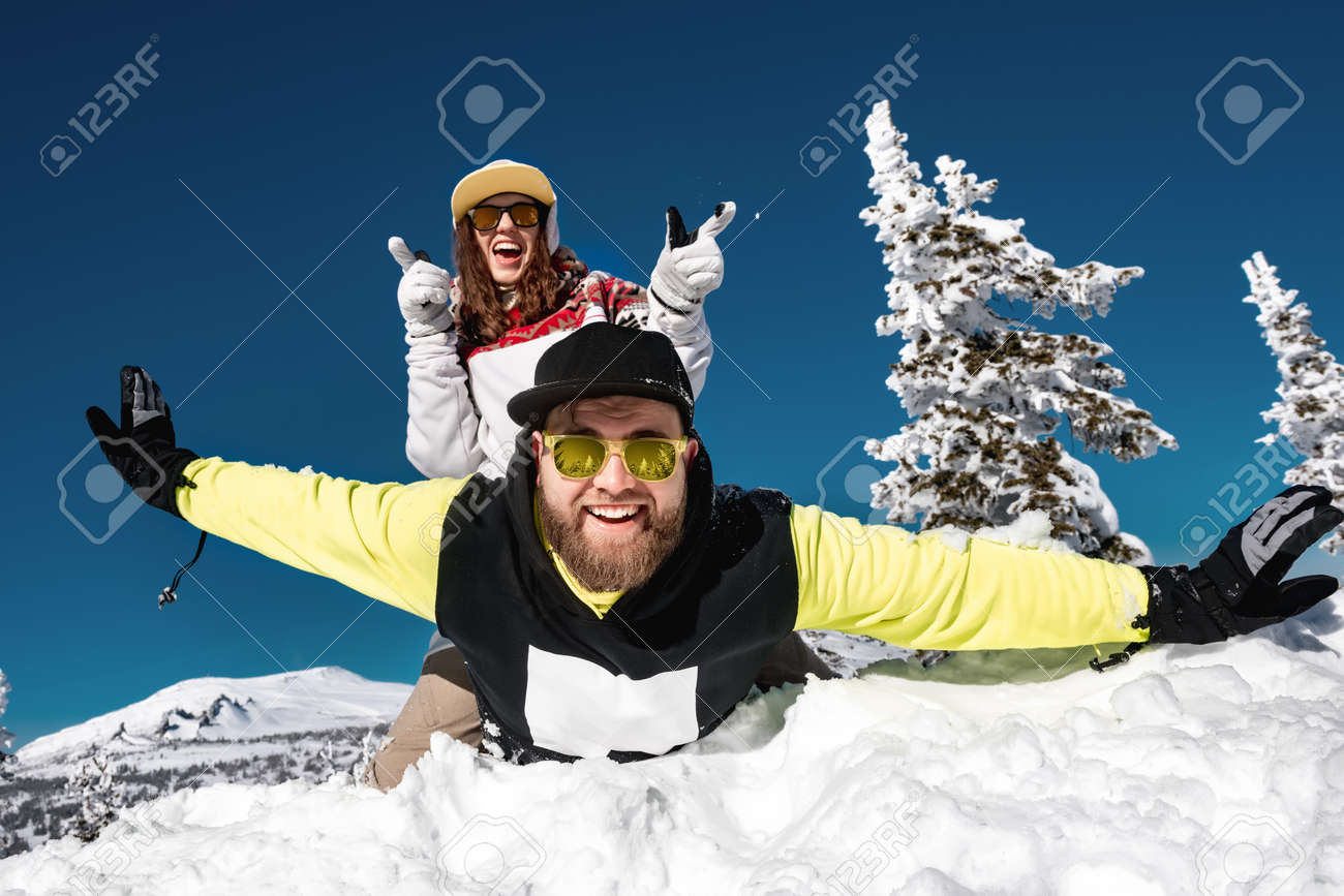 Couple snowboarders or skiers are having fun at ski resort. Sheregesh, Siberia, Russia - 165286916 Couple snowboarders or skiers are having fun at ski resort. Sheregesh, Siberia, Russia - 165286916