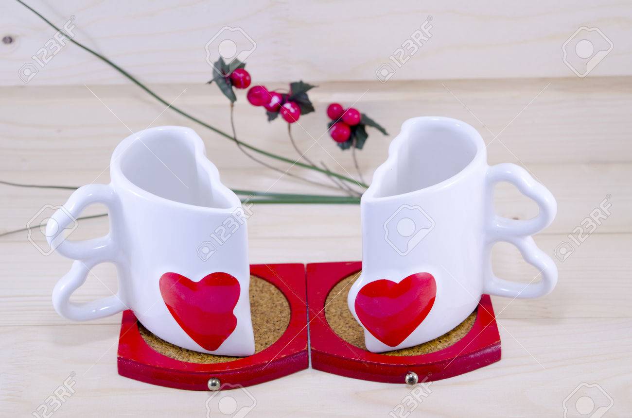 Unique Shaped Coffee Mugs unique heart shaped coffee mug split apart on a wooden table stock Unique Shaped Coffee Mugs unique heart shaped coffee mug split apart on a wooden table stock