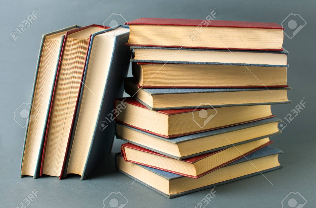 bunch of stacked books against blue background stock photo picture