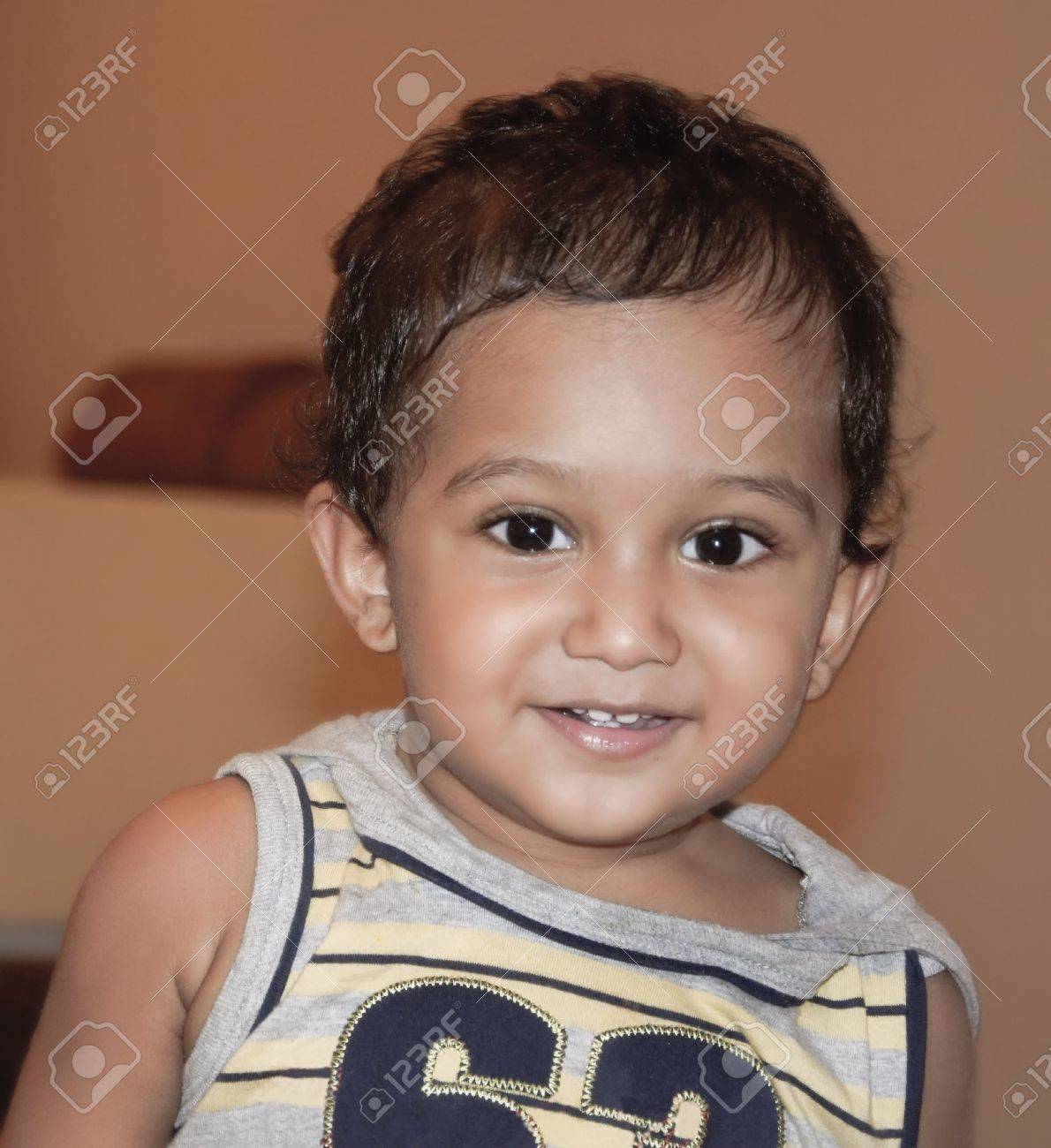 Small Indian Ethnic Infant With A Happy Surprised Look Stock Photo, Picture  And Royalty Free Image. Image 12500975.