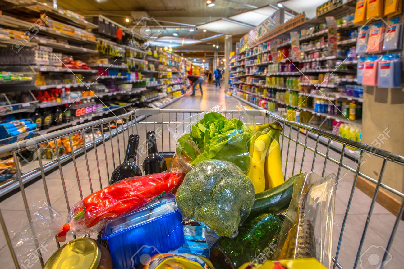 Grocery cart at a supermarket aisle filled up with food products seen from the customers point of view - 48926764 Grocery cart at a supermarket aisle filled up with food products seen from the customers point of view - 48926764