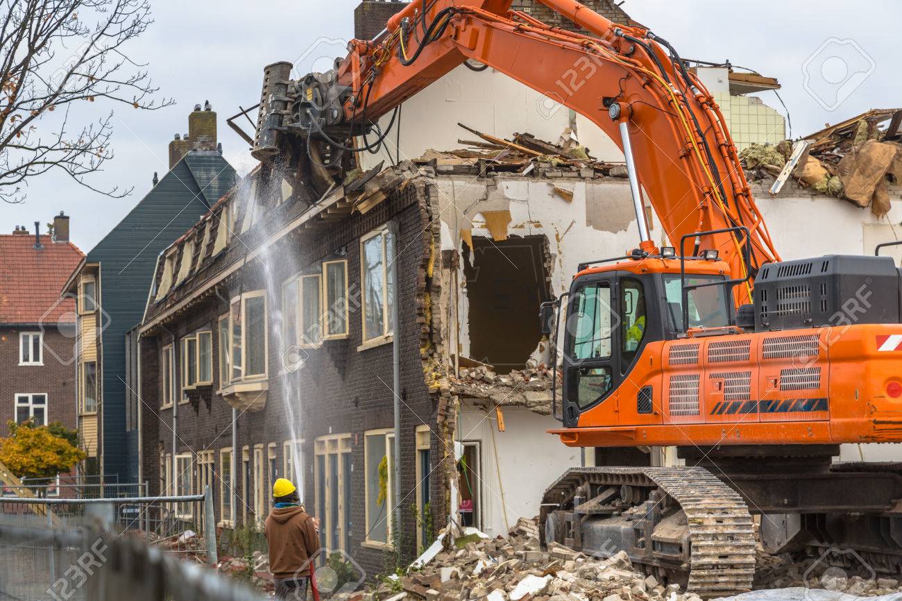 Orange Demolition crane demolishing old row of houses in the Netherlands - 84572478 Orange Demolition crane demolishing old row of houses in the Netherlands - 84572478