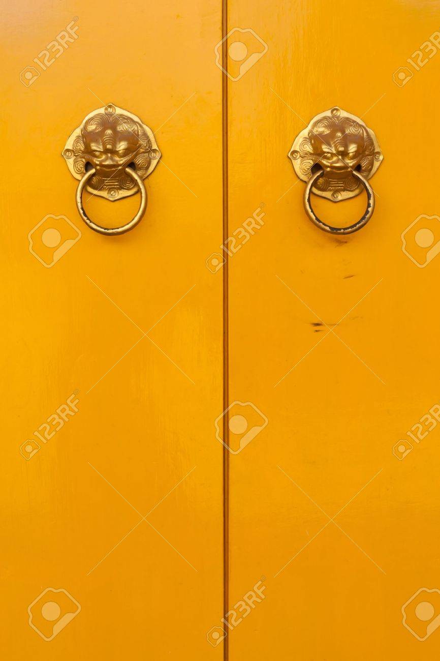 Golden chinese door handles on yellow doors in vertical - 10103835 Golden chinese door handles on yellow doors in vertical - 10103835