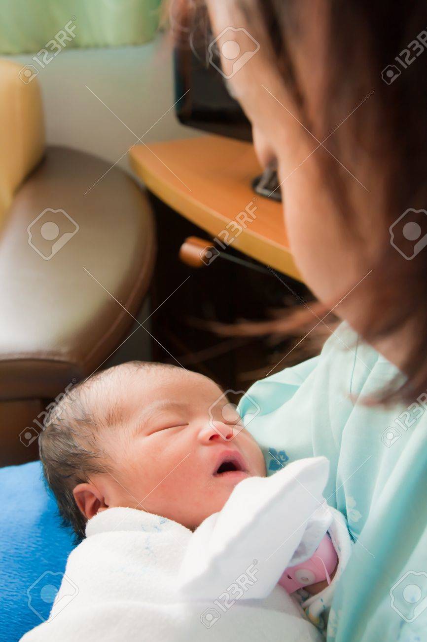 Face of Asian female newborn fall asleep in mother - 10746584 Face of Asian female newborn fall asleep in mother - 10746584