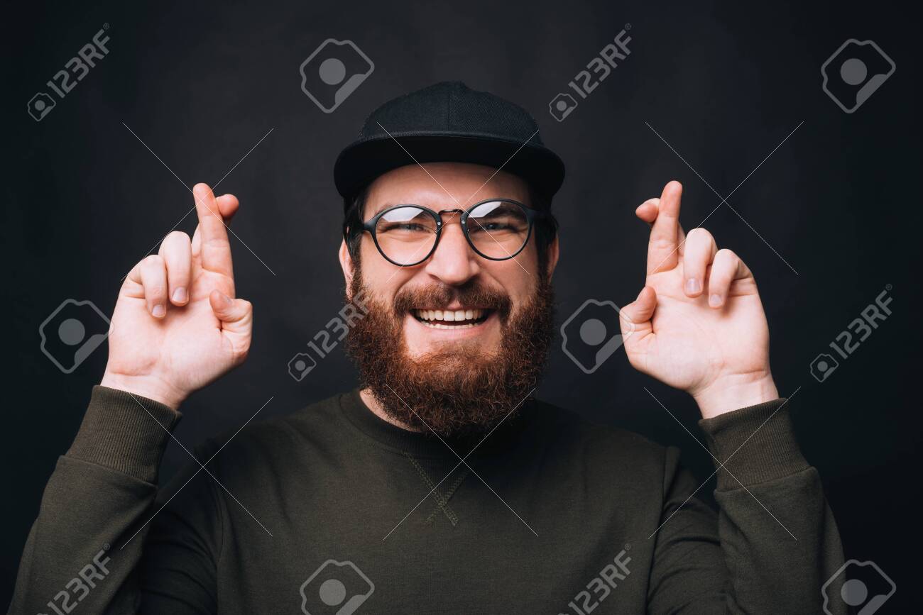 I Hope So Smiling Bearded Man Wearing Eyeglasses Is Crossing Stock Photo Picture And Royalty Free Image Image