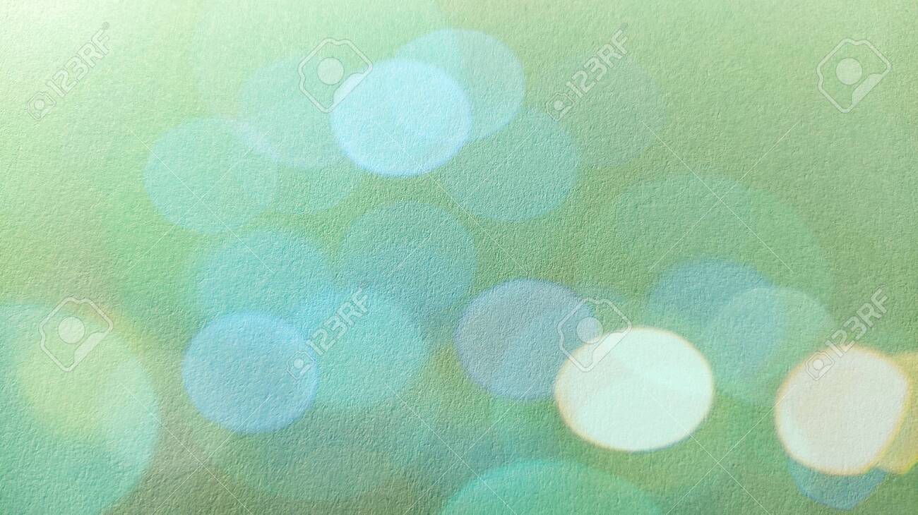Green Background With Bokeh Effect. A Calm Green Hue Reminiscent Of A  Grassy Tone. Soothing Interior Color. Texture Of Printing Paper. Close-up.  Blue And Green Bokeh. Stock Photo, Picture And Royalty Free