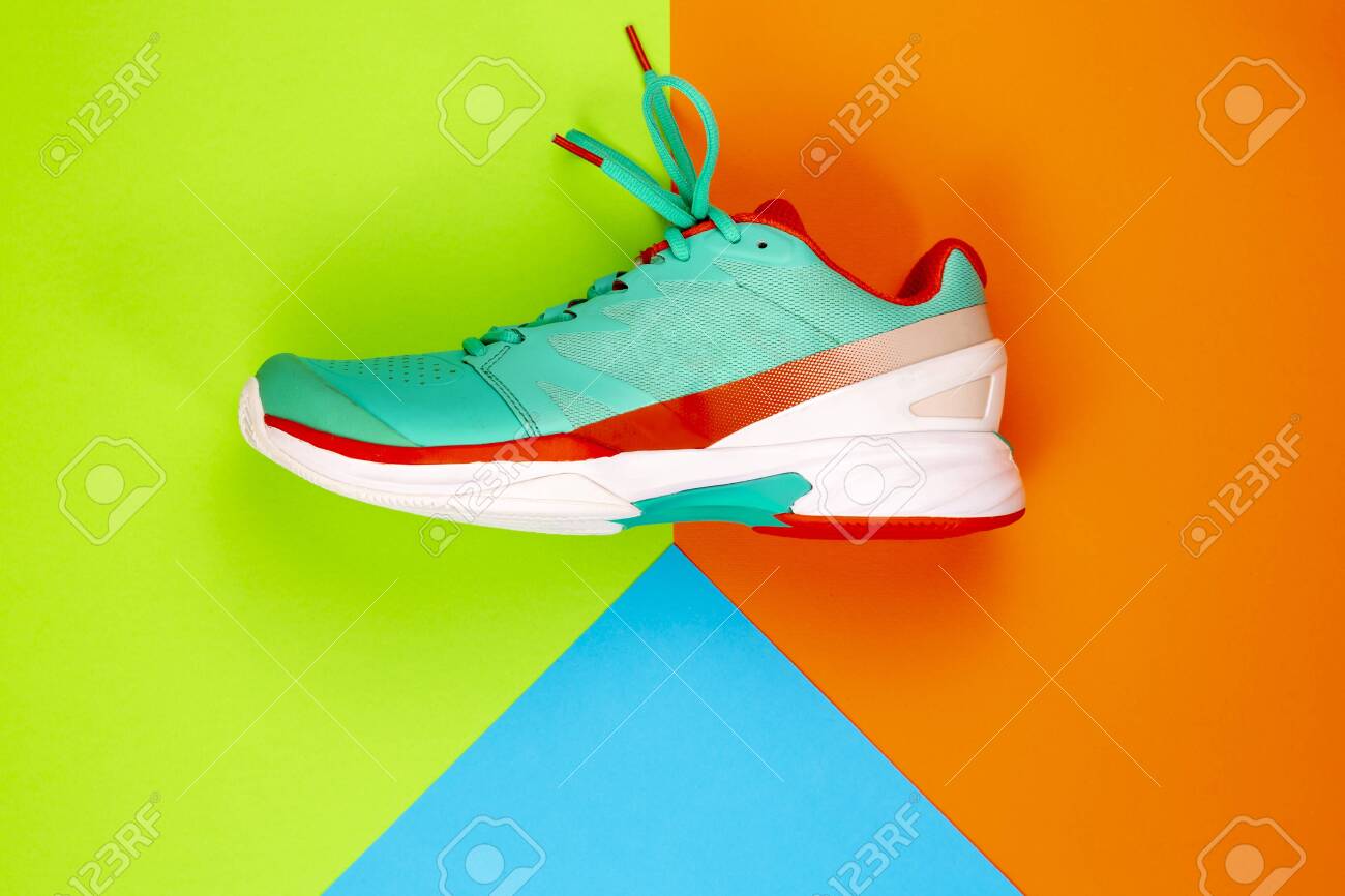 orange and green tennis shoes
