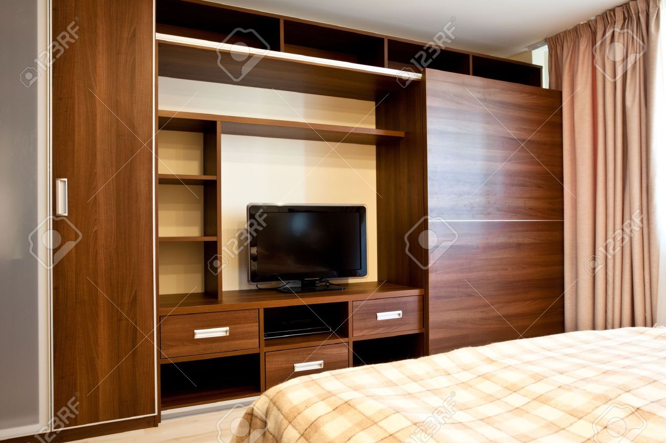Comfortable Bedroom With Tv And Wardrobes Stock Photo Picture And