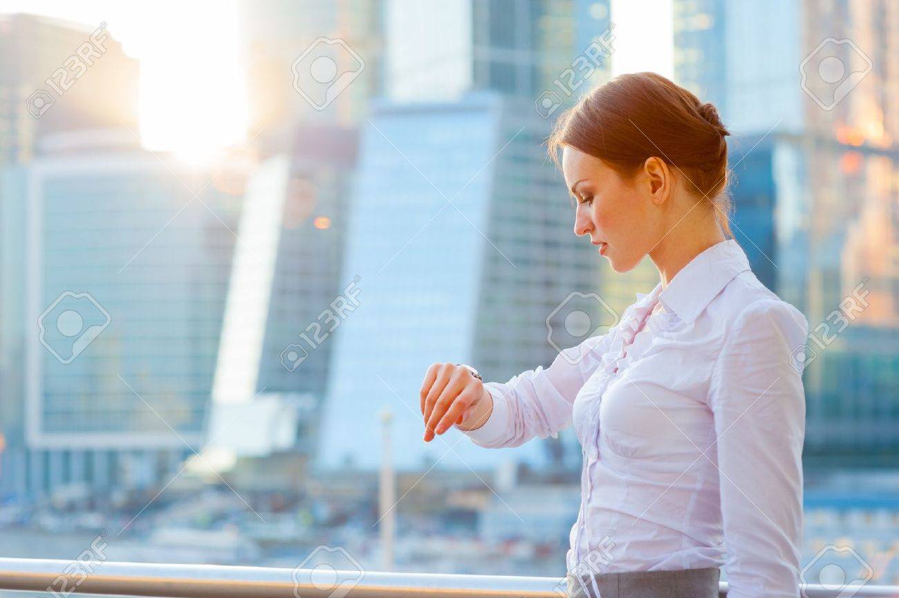 Business woman. What time is it? . Sun beams. - 19203113 Business woman. What time is it? . Sun beams. - 19203113
