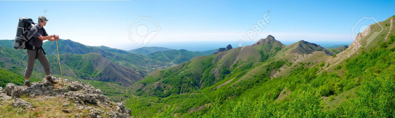 Hiker on the top enjoys panorama landscape - 25025016 Hiker on the top enjoys panorama landscape - 25025016