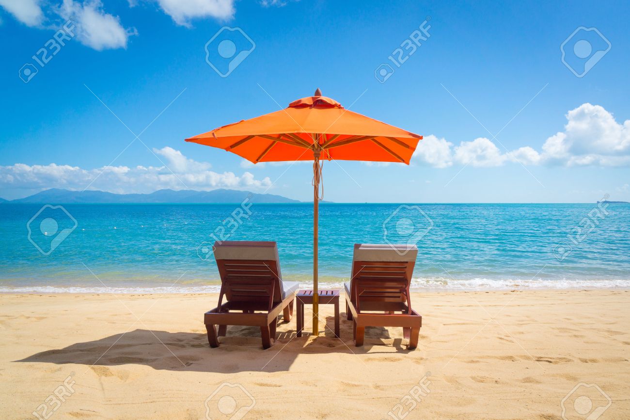 Two lounge chairs with sun umbrella on a beach - 28350692 Two lounge chairs with sun umbrella on a beach - 28350692