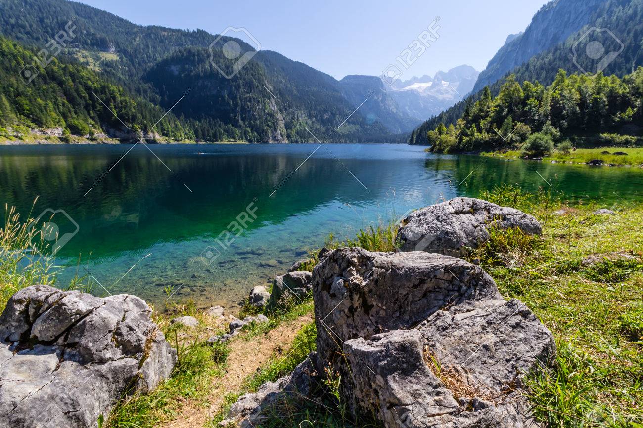 Beautiful landscape of alpine lake with crystal clear green water and mountains in background, Gosausee, Austria - 55923619 Beautiful landscape of alpine lake with crystal clear green water and mountains in background, Gosausee, Austria - 55923619
