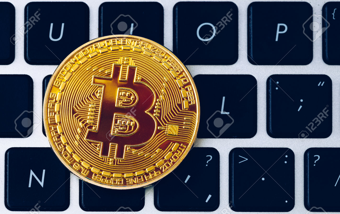 Bitcoin on compuer keyboard in background, symbol of electronic virtual money and mining cryptocurrency concept. Coin crypto currency bitcoin lies on the keyboard. Bitcoin on keyboard. - 168255337 Bitcoin on compuer keyboard in background, symbol of electronic virtual money and mining cryptocurrency concept. Coin crypto currency bitcoin lies on the keyboard. Bitcoin on keyboard. - 168255337