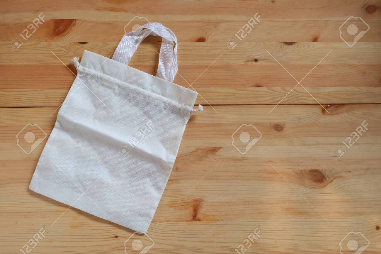 Empty White Canvas Cloth Bag On Wooden Floor Replace Plastic