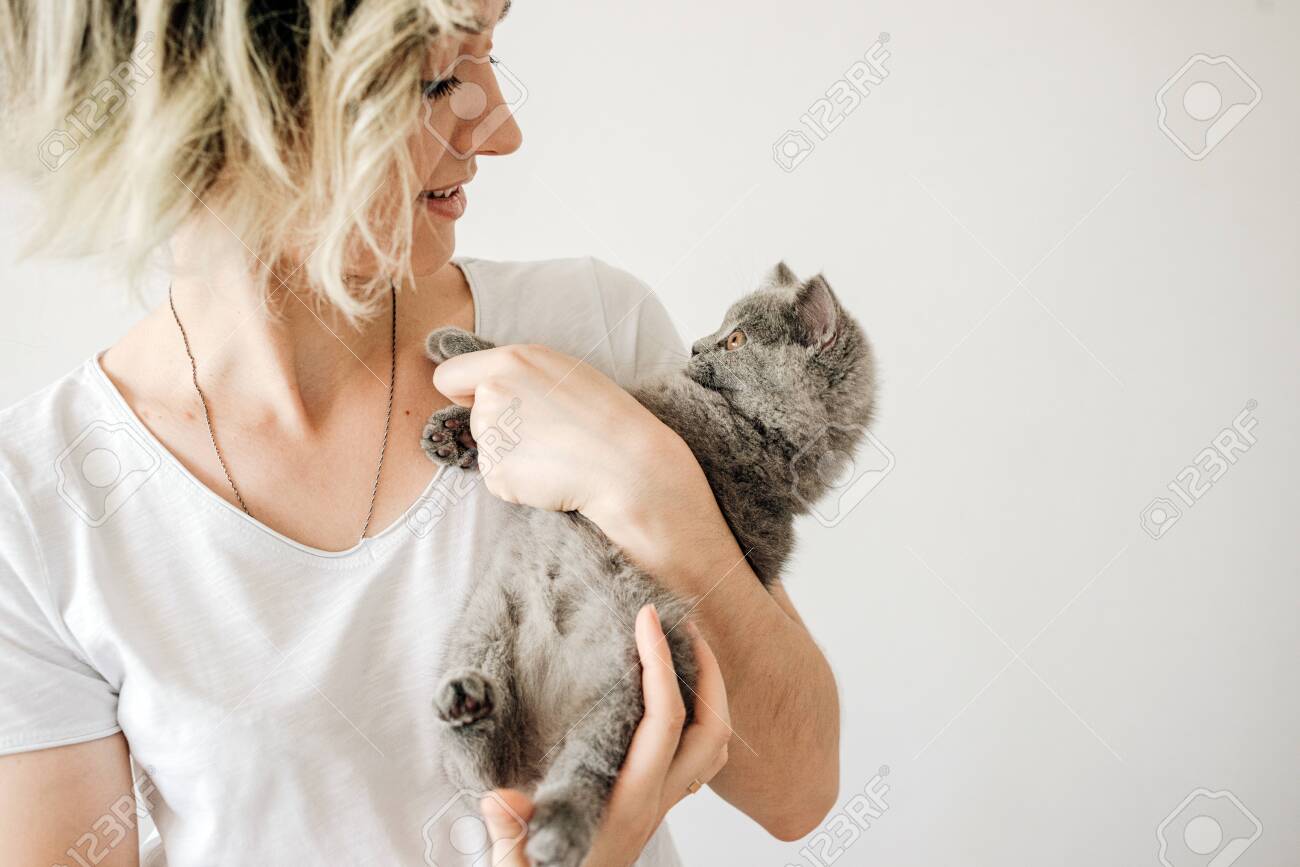 Beautiful Young Woman With Cute Cat Resting At Home The British