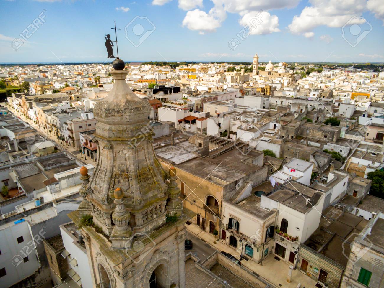Aerial View Of The Belltower Of The Church Of St. John Baptist In The Town  Of Sava, Near Taranto, In The South Of Italy On Partially Cloudy Sky  Background Stock Photo, Picture, image size:1300x977