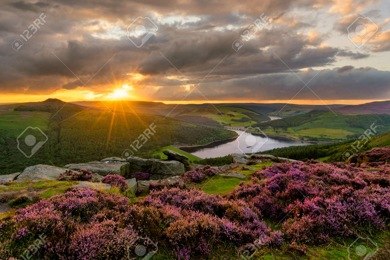 Evening sun bursting through dramatic clouds with epic view of Ladybower Reservoir in the Peak District. - 159217218 Evening sun bursting through dramatic clouds with epic view of Ladybower Reservoir in the Peak District. - 159217218
