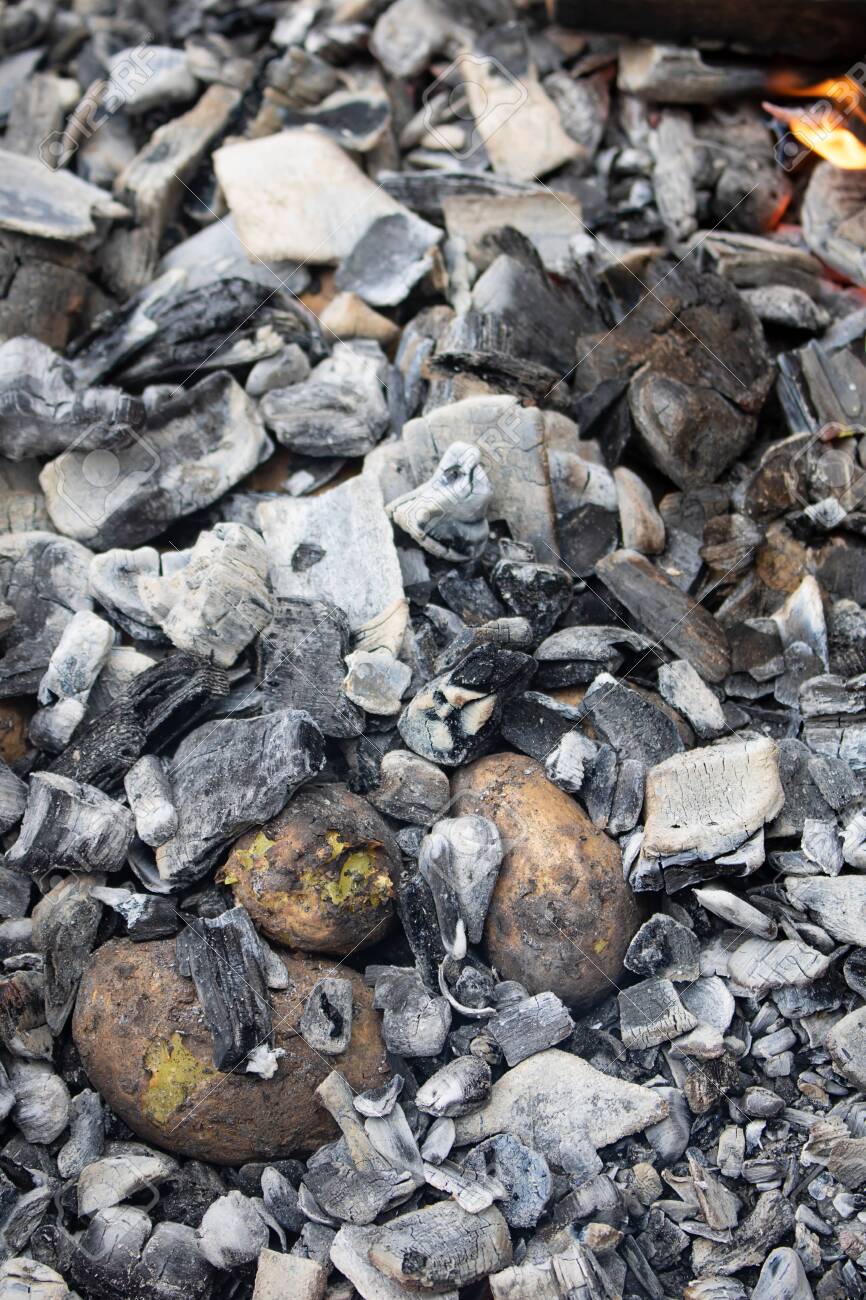raw potato baked in hot charcoal, nobody - 134038521 raw potato baked in hot charcoal, nobody - 134038521