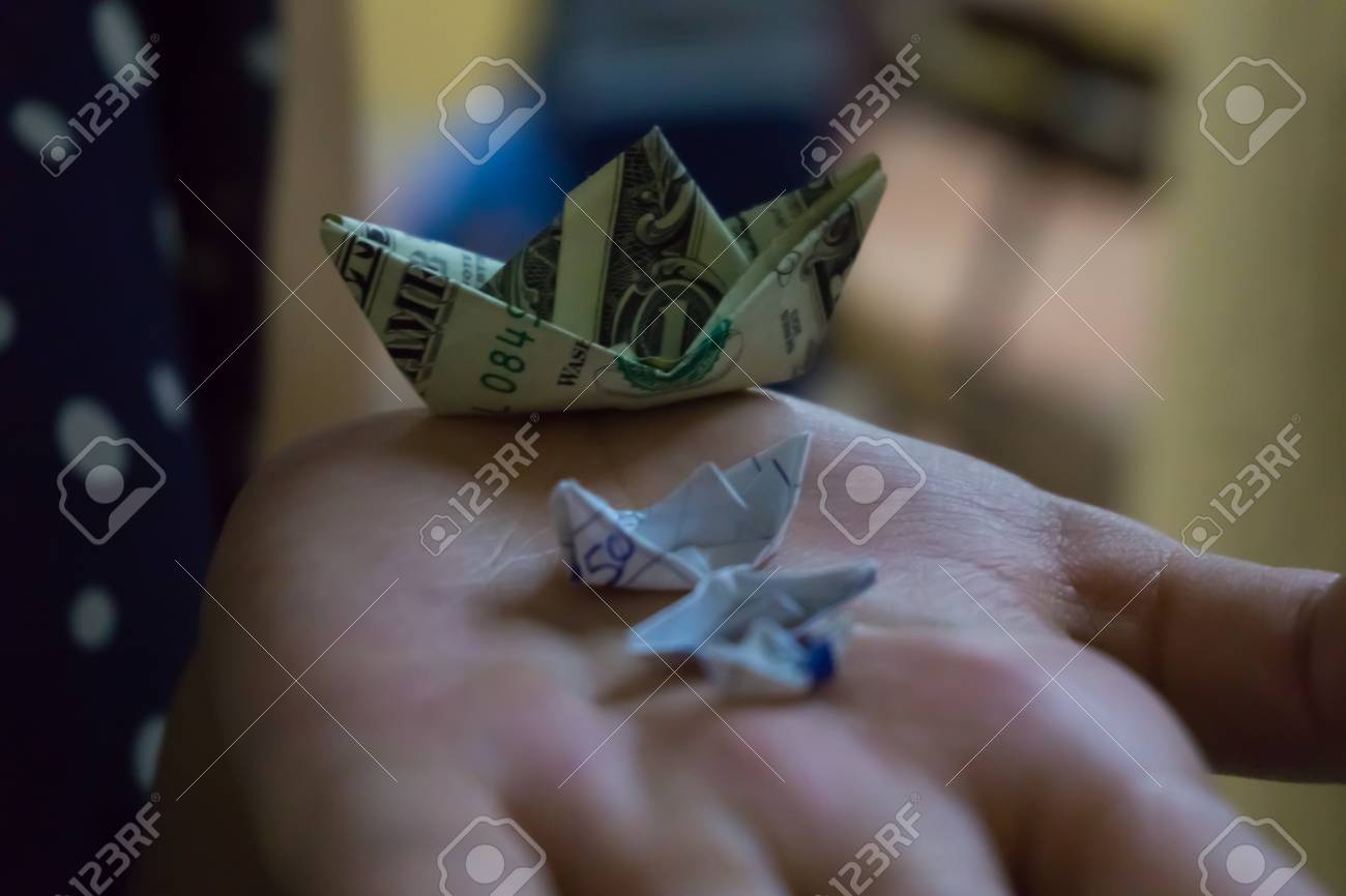Stock P O Three Paper Boats And A Boat Made With A Dollar Bill On One Hand Stock P O Three Paper Boats And A Boat Made With A Dollar Bill On One Hand