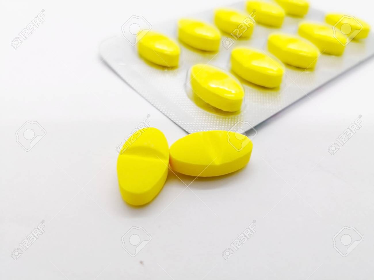 medication and healthcare concept many yellow pills of paracetamol