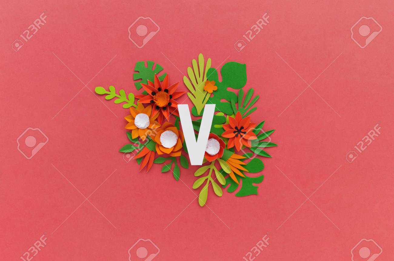 letter v of the alphabet cut out of white paper surrounded by paper flower cut out