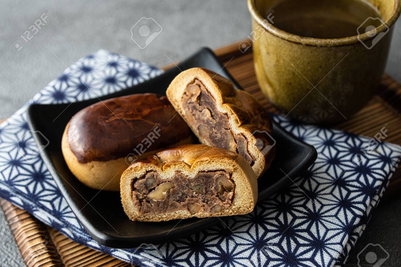 Manju, a traditional Japanese sweet snack often served with green tea. - 149442316 Manju, a traditional Japanese sweet snack often served with green tea. - 149442316