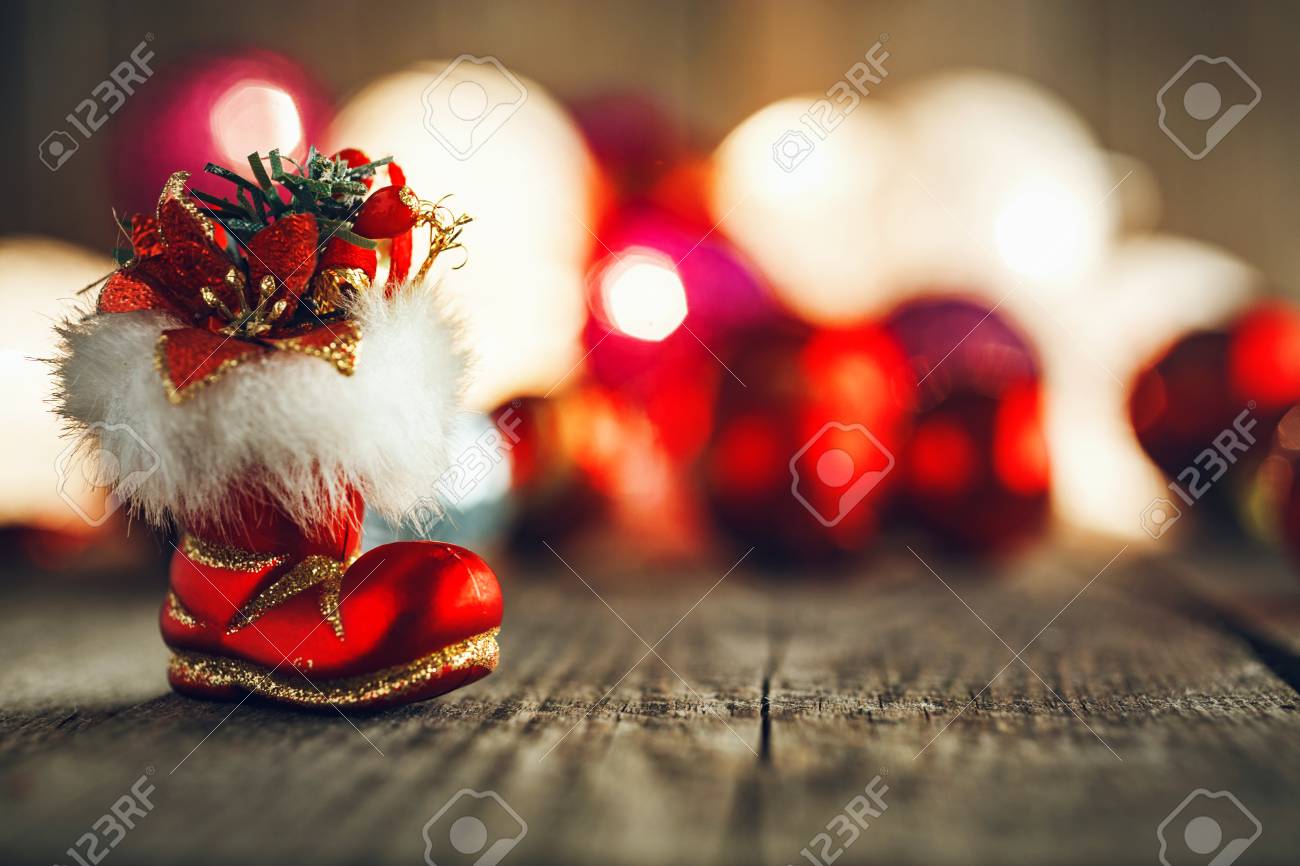 red christmas boo on rustic wooden board soft bokeh lights and christmas boo