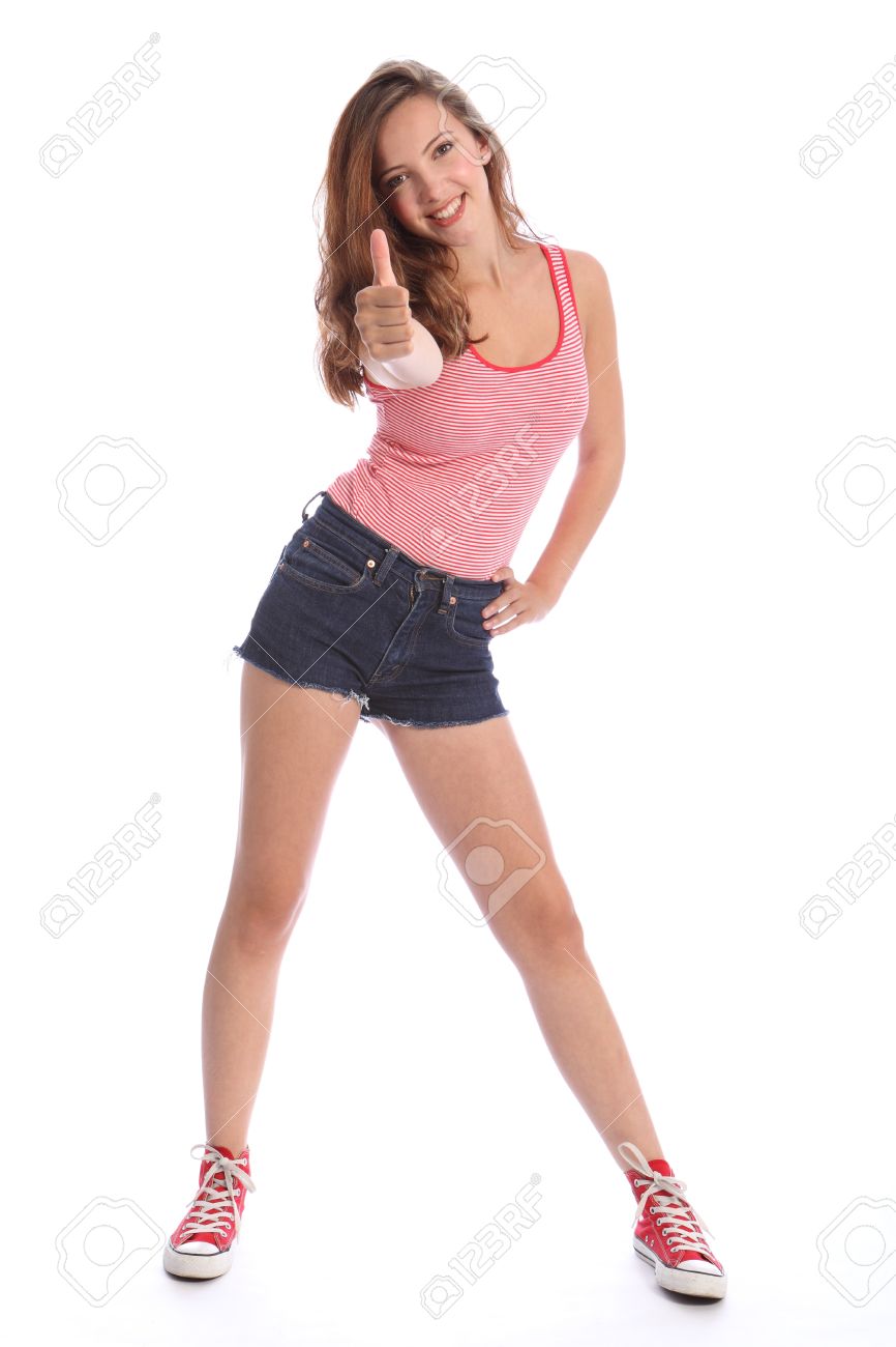 美しい若い 10 代の学校の女の子 16 による標識親指の成功 長い茶色の髪青いデニムを身に着けて切断ショート パンツし赤い靴の赤と白のベストします 彼女は幸せな笑顔をが の写真素材 画像素材 Image