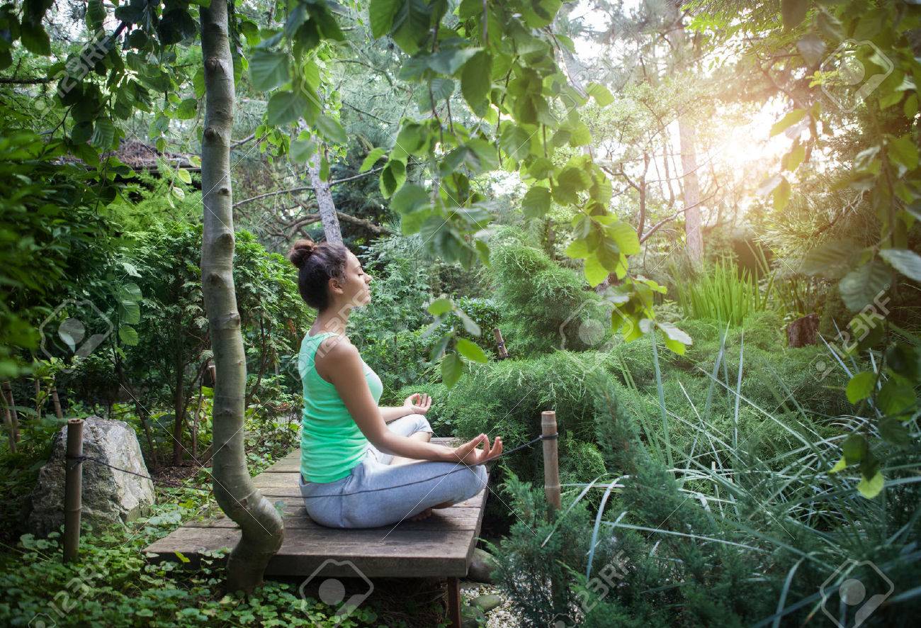 Young woman doing yoga asana in the evening outdoors - 43958064 Young woman doing yoga asana in the evening outdoors - 43958064