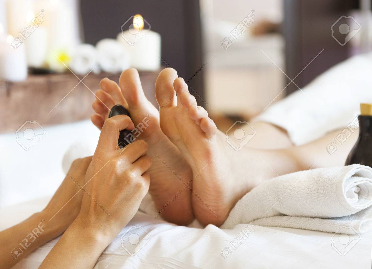 Massage of human feet by hot stones in spa salon. Close up - 47462036 Massage of human feet by hot stones in spa salon. Close up - 47462036