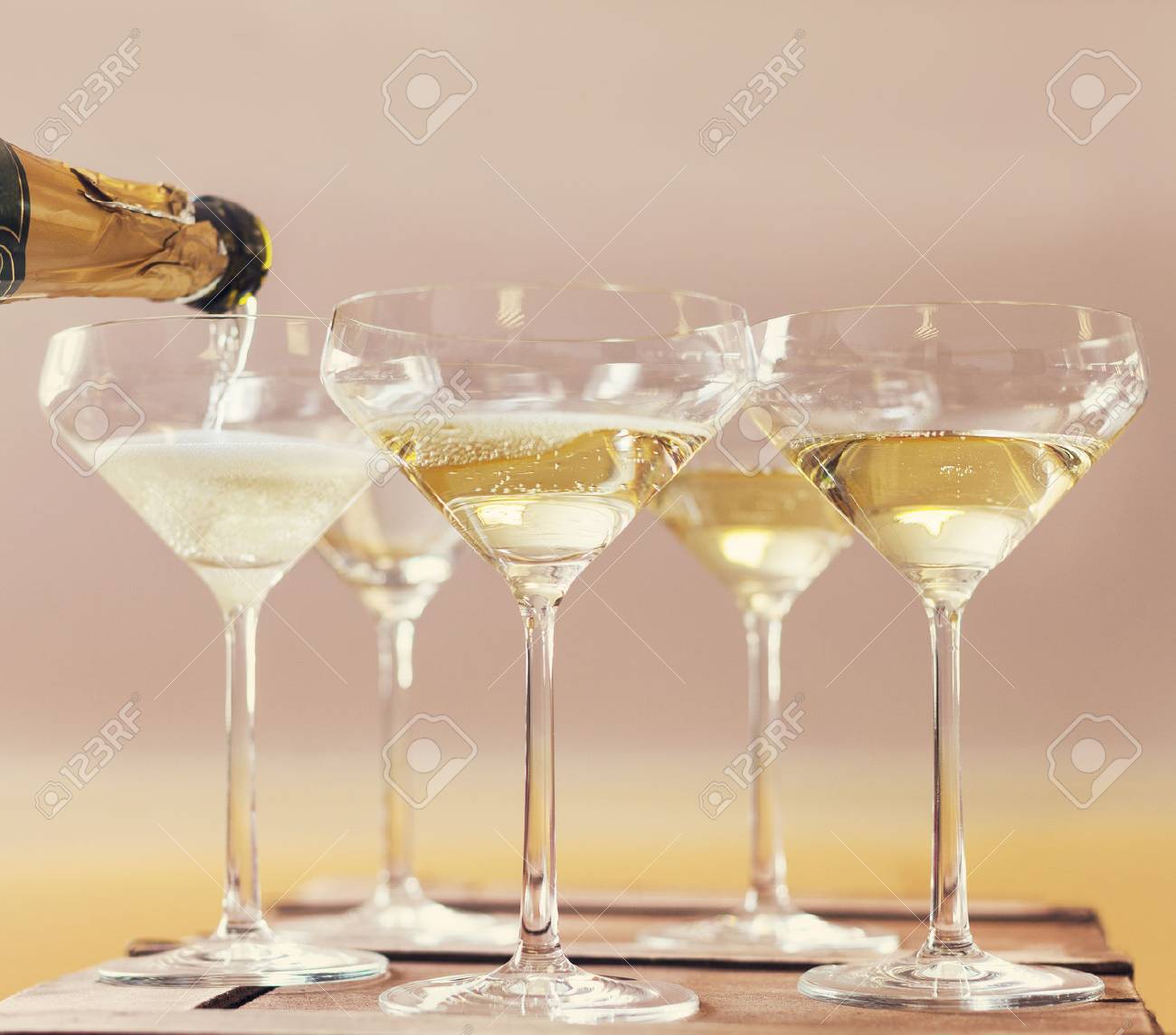Champaign being pored into glasses. Retro toned image - 48008917 Champaign being pored into glasses. Retro toned image - 48008917
