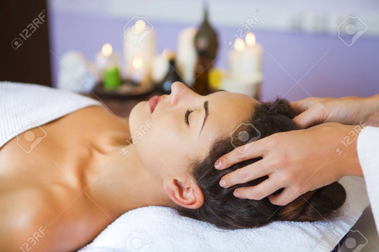 Close up portrait of a young woman getting spa treatment. Head massage - 50767272 Close up portrait of a young woman getting spa treatment. Head massage - 50767272